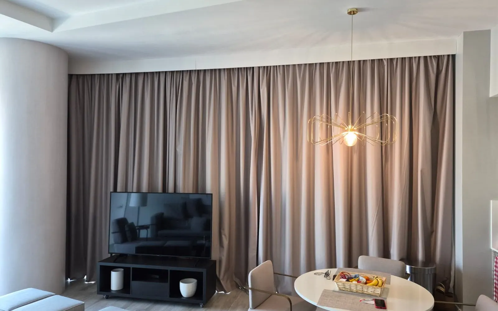 Pinch-pleat draperies framing a tall window
