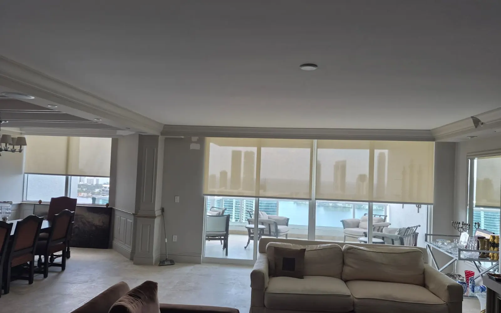 Roller shade lowered over a sunlit window